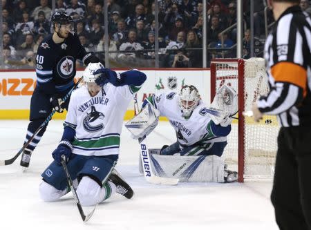 Dec 11, 2017; Winnipeg, Manitoba, CAN; Winnipeg Jets left wing Nikolaj Ehlers (27) (not in photo) scores on Vancouver Canucks goalie Jacob Markstrom (25) in second period action as Vancouver Canucks defenseman Alexander Edler (23) tries to block the shot at Bell MTS Place. Mandatory Credit: James Carey Lauder-USA TODAY Sports