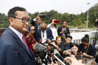 Cambodia's exiled opposition leader Sam Rainsy talks to the media outside Parliament House in Kuala Lumpur, Malaysia, Tuesday, Nov. 12, 2019. Rainsy landed in Kuala Lumpur in a bid to return to his homeland after Thailand had earlier blocked him from entering. (AP Photo/Vincent Thian)