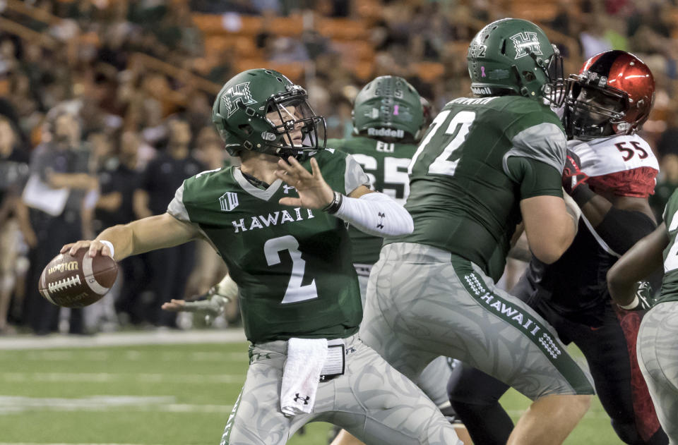 Hawaii quarterback Dru Brown (2) drops back to pass in the third quarter of an NCAA college football game against San Diego State, Saturday, Oct. 28, 2017, in Honolulu. (AP Photo/Eugene Tanner)