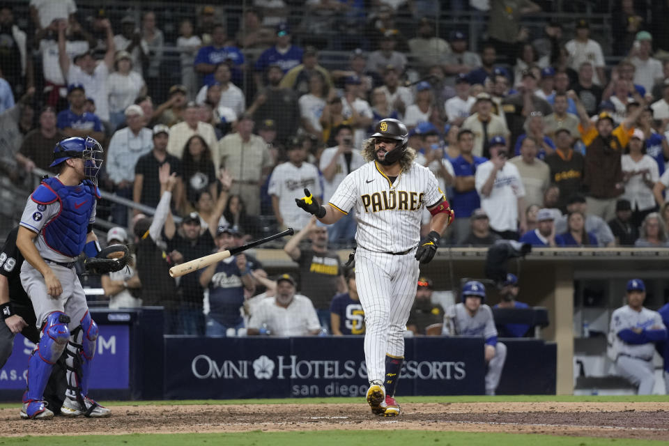 San Diego Padres' Jorge Alfaro reacts after drawing a walk with the bases loaded, allowing the winning run to score during the 10th inning against the Los Angeles Dodgers in a baseball game Tuesday, Sept. 27, 2022, in San Diego. (AP Photo/Gregory Bull)