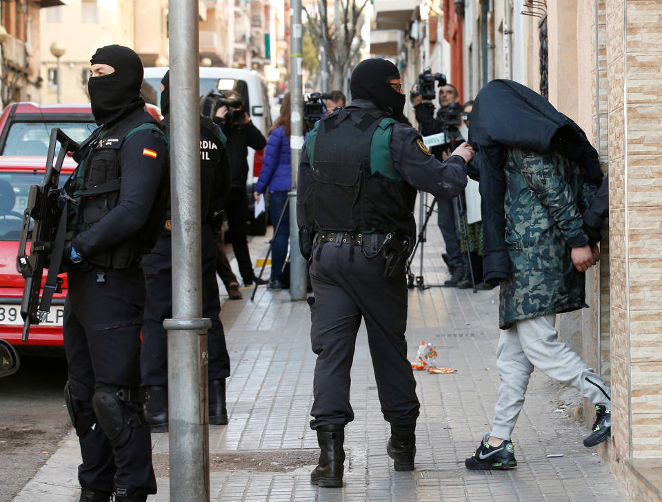 Spanish civil guards escort a detained suspect in Badalona