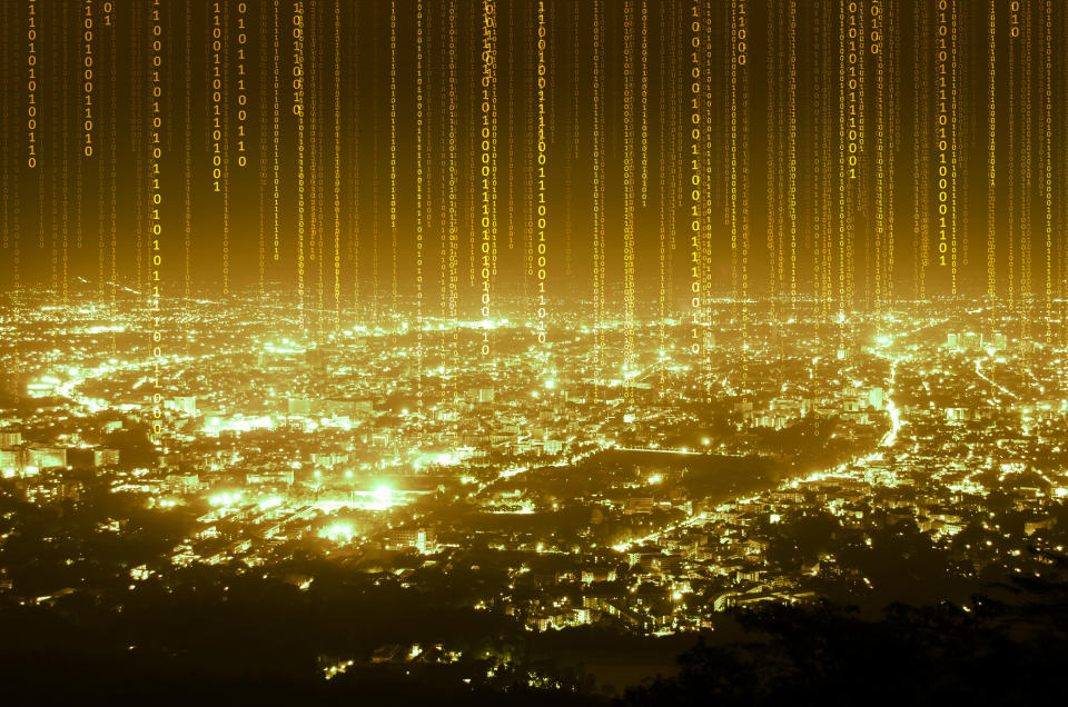 Illuminated gold code streaming from a cityscape.