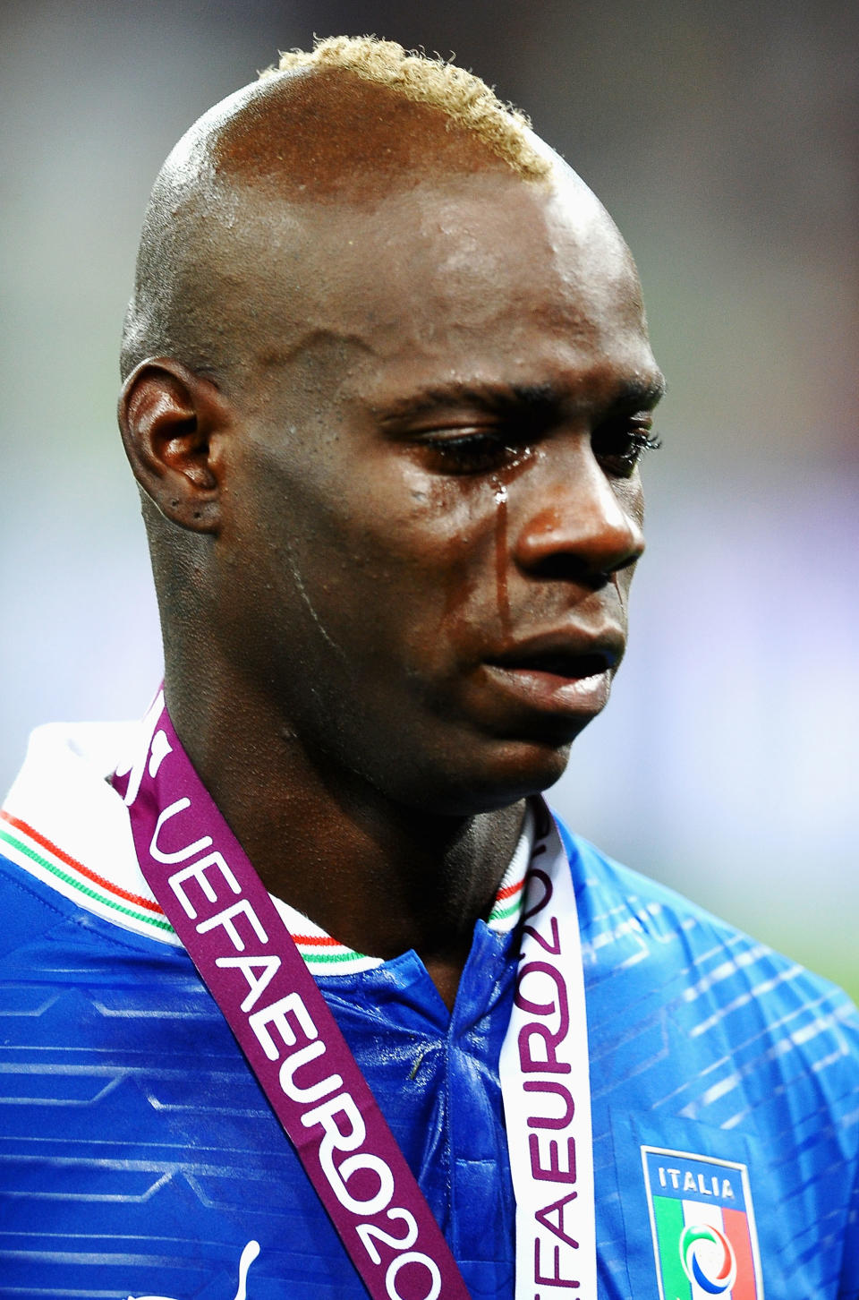 KIEV, UKRAINE - JULY 01: Mario Balotelli of Italy cries as he shows his dejection following defeat in the UEFA EURO 2012 final match between Spain and Italy at the Olympic Stadium on July 1, 2012 in Kiev, Ukraine. (Photo by Laurence Griffiths/Getty Images)