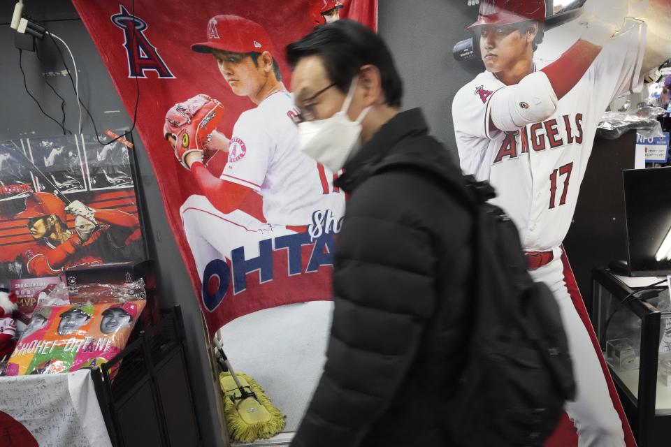 Customers shop around for character goods of Shohei Ohtani of the Los Angeles Dodgers at a sporting goods store, "SELECTION," in Shinjuku district Wednesday, Dec. 13, 2023, in Tokyo. Ohtani agreed to a record $700 million, 10-year contract with the Los Angeles Dodgers. (AP Photo/Eugene Hoshiko)