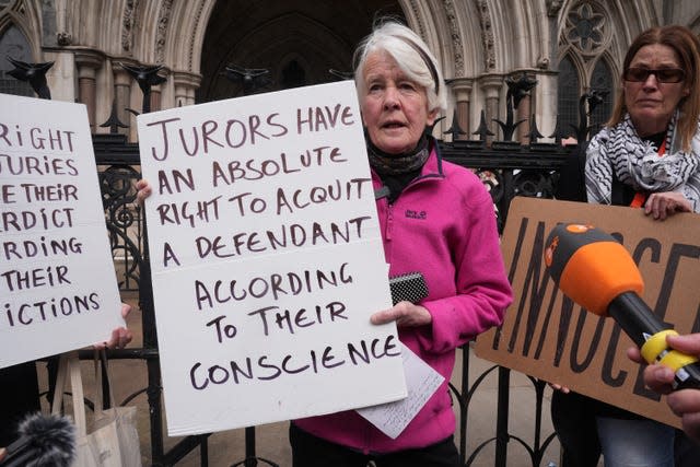 Trudi Warner holding a sign outside the Royal Courts of Justice in London (Lucy North/PA)