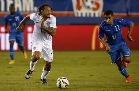 Oct 14, 2014; Boca Raton, FL, USA; USA midfielder Jermaine Jones (13) battles for the ball with Honduras Roger Rojas (21) the first half at FAU Stadium. Robert Mayer-USA TODAY Sports