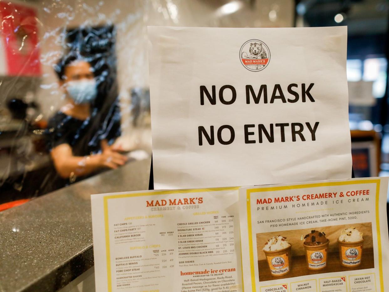 FILE PHOTO: A "no mask, no entry" reminder for take-away customers and delivery riders is posted outside a restaurant to prevent the spread of the coronavirus disease (COVID-19), in Quezon City, Metro Manila, Philippines, July 8, 2020. REUTERS/Eloisa Lopez/File Photo