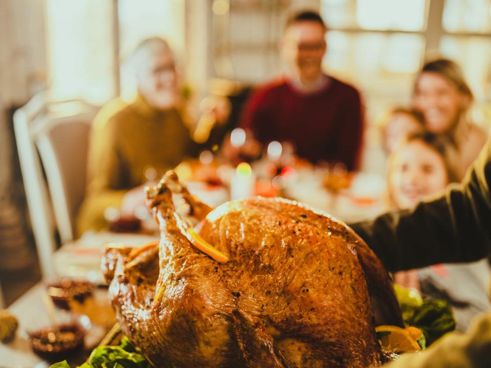 thanksgiving turkey on a table with people in the background