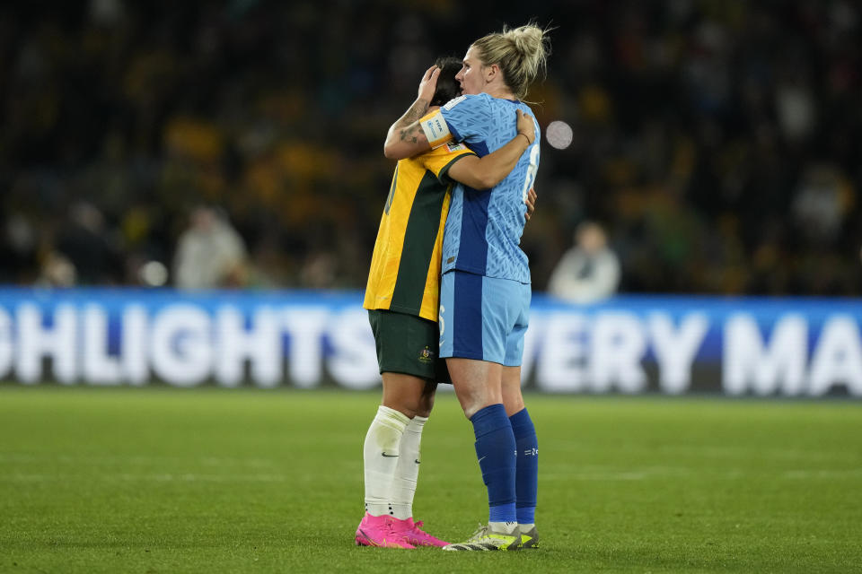 England's captain Millie Bright, right, comforts Australia's captain Sam Kerr after England won the Women's World Cup semifinal soccer match between Australia and England at Stadium Australia in Sydney, Australia, Wednesday, Aug. 16, 2023. (AP Photo/Rick Rycroft)