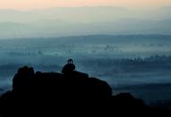 While the sun rises, the early morning mist fights a losing battle and eases away, revealing a breathtaking view of the hills on the far right of the Matanga hill. Green fields at the banks of the Tungabhadra River and a lone 'mantapa' on a rock complete this view.<br><br>