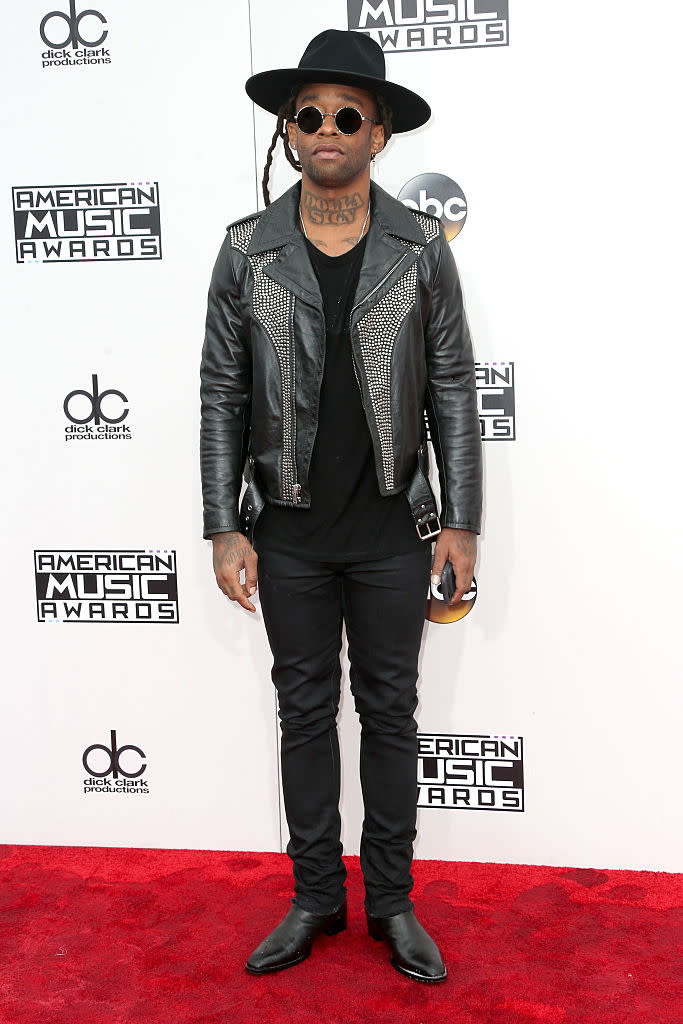 Ty Dolla Sign accessorized with a hat and round sunglasses