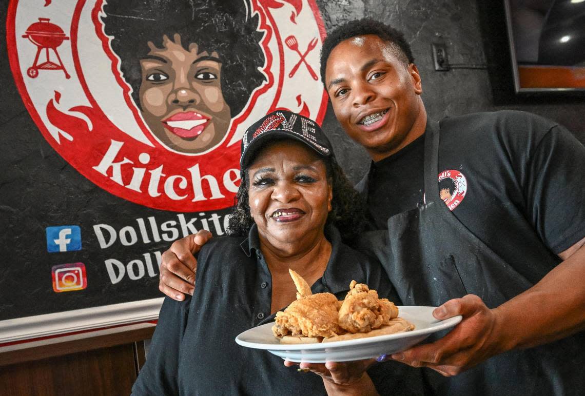 Gloria Hall and her son Johnny Smith hold up a plate of chicken and waffles at Doll’s Kitchen in Fresno where several family members work cooking up soul food in the shopping center southwest of the intersection of Shaw and Blackstone in Fresno.