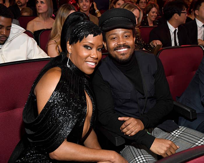 regina and her son seated at an event, smiling