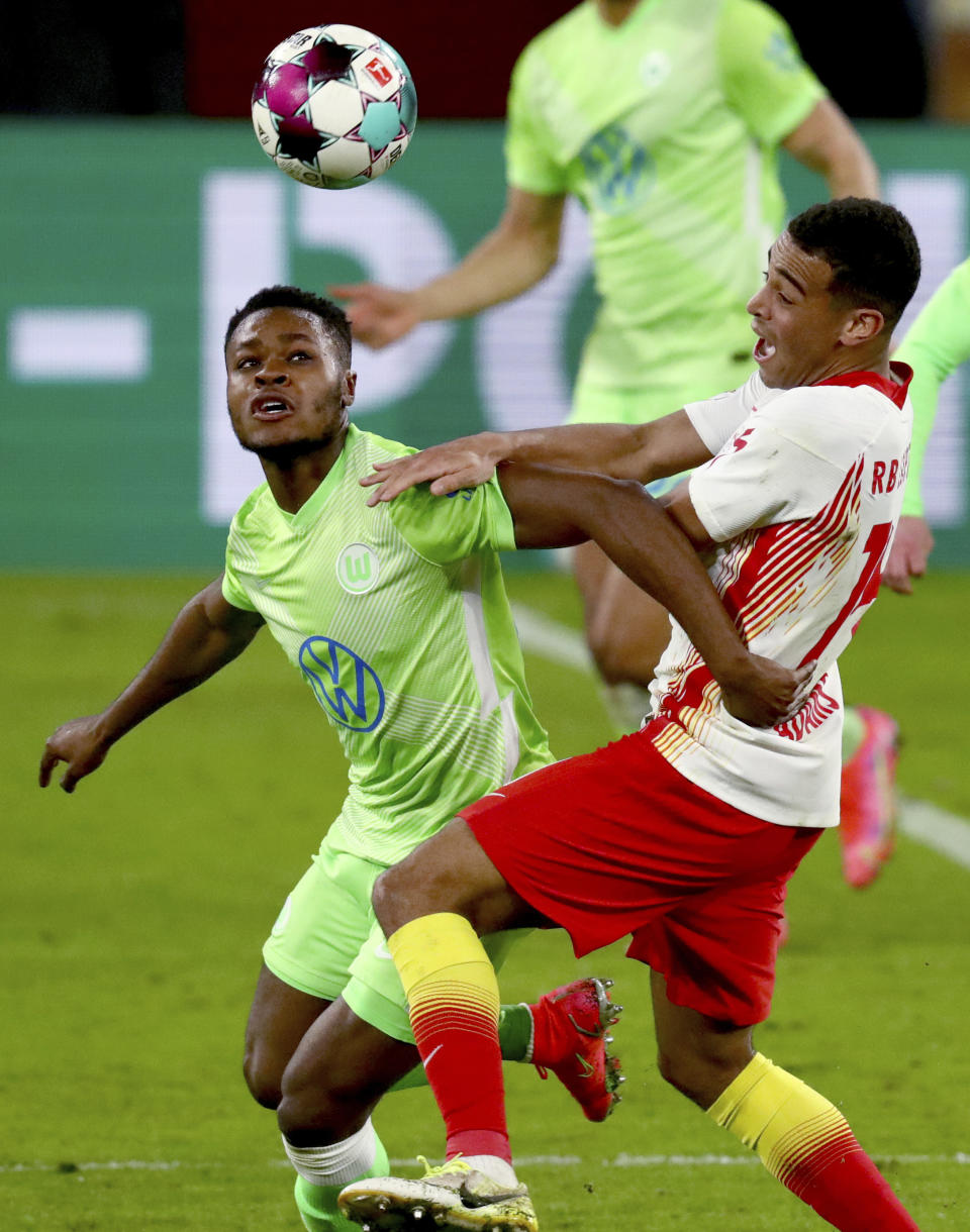 Wolfsburg's Bote Baku, left, and Leipzig's Tyler Adams, right, challenge for the ball during the German soccer cup, DFB Pokal, quarter final match between RB Leipzig and VfL Wolfsburg in Leipzig, Germany, Wednesday, March 3, 2021. (AP Photo/Michael Sohn)