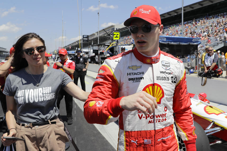 Josef Newgarden walks with his fiancée Ashley Welsh after he qualified for the Indianapolis 500 IndyCar auto race at Indianapolis Motor Speedway, Saturday, May 18, 2019, in Indianapolis. Welsh joined some of the other drivers' significant others in wearing T-shirts that said, "Not YOUR Body, Not YOUR Choice." Indiana is among a handful of states moving to restrict abortions in the hopes that the U.S. Supreme Court will overturn its 1973 decision in Roe. vs. Wade. (AP Photo/Darron Cummings)