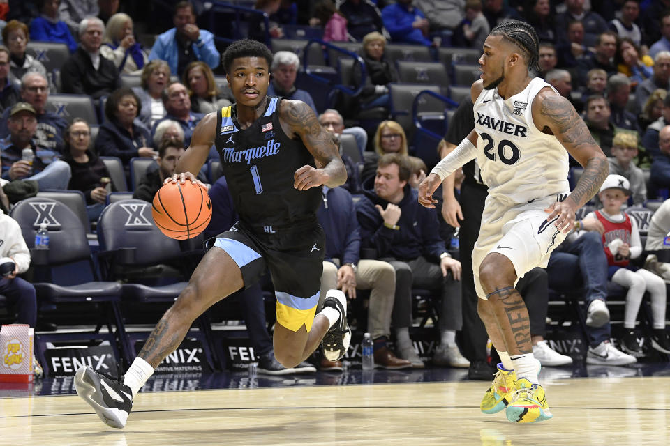 Marquette guard Kam Jones (1) drives past Xavier guard Dayvion McKnight (20) during the second half of an NCAA college basketball game in Cincinnati, Saturday, March 9, 2024. Marquette won 86-80. (AP Photo/Timothy D. Easley)