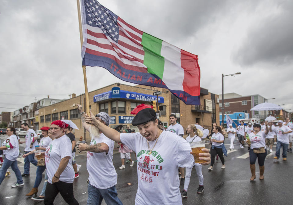 <p>Mari Caraballo, with Golden Slippers Brigade, center, waves her Italian flag as part of the Columbus Day parade on Broad Street in Philadelphia, Pa., on Sunday, Oct. 8, 2017. (Photo: Michael Bryant/The Philadelphia Inquirer via AP) </p>