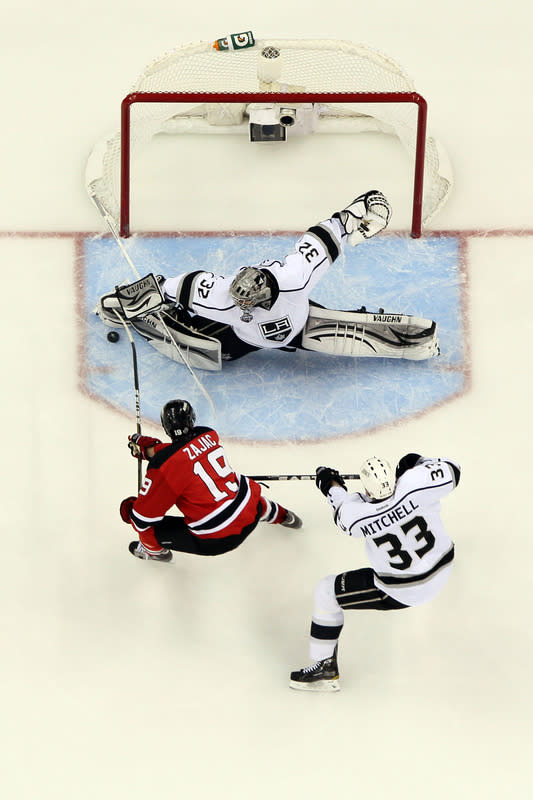 NEWARK, NJ - JUNE 09: Jonathan Quick #32 of the Los Angeles Kings makes a save in front of Travis Zajac #19 of the New Jersey Devils and Willie Mitchell #33 during Game Five of the 2012 NHL Stanley Cup Final at the Prudential Center on June 9, 2012 in Newark, New Jersey. (Photo by Jim McIsaac/Getty Images)