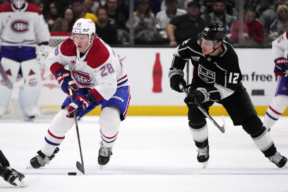 Montreal Canadiens center Christian Dvorak (28) skates past Los Angeles Kings center Trevor Moore (12) during the first period of an NHL hockey gam,e Saturday, Nov. 25, 2023, in Los Angeles. (AP Photo/Marcio Jose Sanchez)