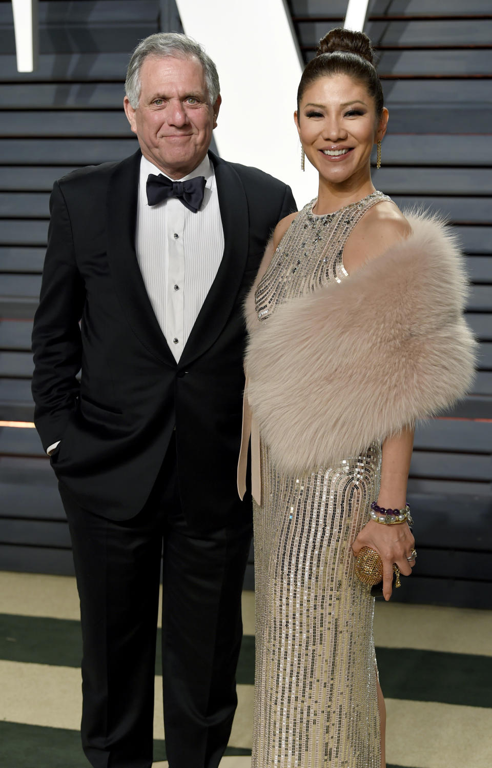 FILE - In this Feb. 26, 2017 file photo, Les Moonves, left, and Julie Chen arrive at the Vanity Fair Oscar Party in Beverly Hills, Calif. Chen was absent from her talk CBS show, “The Talk” a day after a new round of sexual misconduct allegations against Moonves brought the departure of the CBS chief executive. In what was supposed to be a celebratory season premiere Monday, Sept. 10, 2018, the show's four other panelists walked out somberly without Chen, who acts as host and moderator. Sharon Osbourne choked back tears as she announced Chen would be taking time off to be with her family, and expressed support for her co-star and friend. (Photo by Evan Agostini/Invision/AP, File)