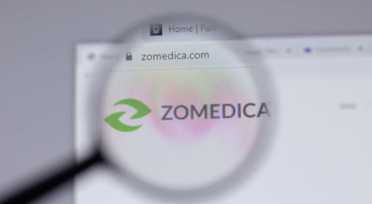 A magnifying glass zooms in on the website for Zomedica (ZOM).