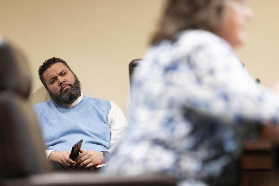 Nebraska state Sen. Justin Wayne listens as Kathy Wilmot testifies against of LB20, a bill to provide restoration of voting rights upon completion of a felony sentence or probation for a felony, during a hearing before the Government, Military and Veterans Affairs committee on Wednesday, Feb. 22, 2023, at the Nebraska state Capitol in Lincoln, Neb. (AP Photo/Rebecca S. Gratz)