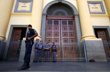 Policemen stand in front of of the Catholic cathedral where a gunman opened fire to the faithful, in Campinas, Brazil, December 11, 2018 REUTERS/Amanda Perobelli