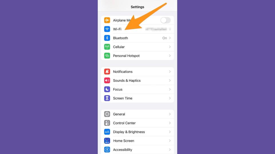 An arrow is pointing down at the Wi-Fi section in the Settings of an iPhone.