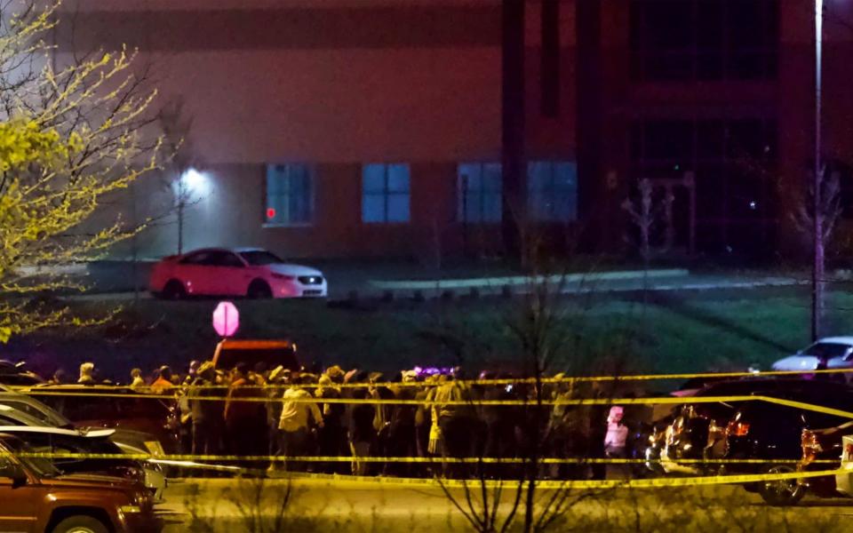 People stand outside a FedEx facility near Indianapolis International Airport after a shooting with multiple victims - Mykal McEldowney/The Indianapolis Star 