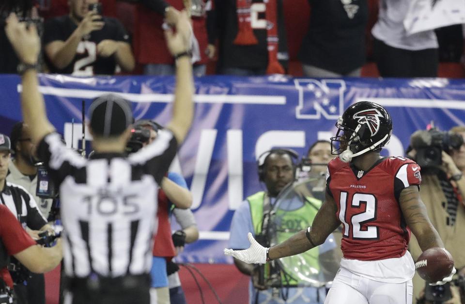 Atlanta Falcons wide receiver Mohamed Sanu (12) celebrates his touchdown against the Seattle Seahawks during the second half of an NFL football divisional football game, Saturday, Jan. 14, 2017, in Atlanta. (AP Photo/David Goldman)