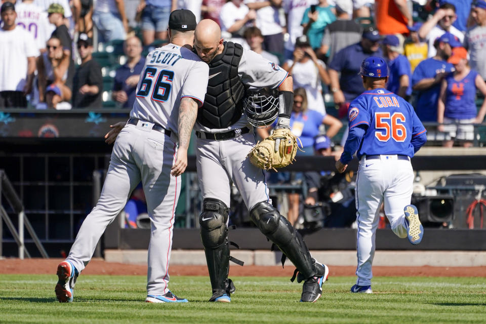 Miami Marlins pitcher Tanner Scott (66) and catcher Jacob Stallings celebrate after the Marlins defeated the New York Mets during their baseball game, Sunday, July 10, 2022, in New York. (AP Photo/Mary Altaffer)