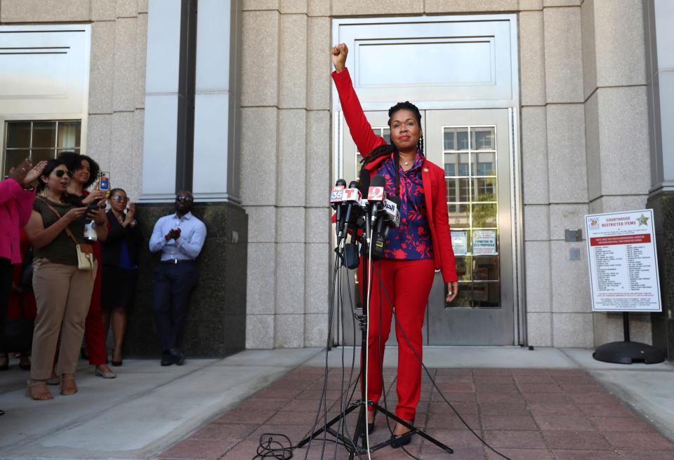 Attorney Monique Worrell of the 9th Judicial Circuit, which serves Orange and Osceola counties, ends her press conference with a raised fist Wednesday, Aug. 9, 2023, outside her former office in the Orange County Courthouse complex in Orlando, Fla. Florida Gov. Ron DeSantis suspended Worrell on Wednesday, again wielding his executive power over local government in taking on a contentious issue in the 2024 presidential race. Worrell vowed to seek reelection next year and said her removal was political and not about her performance. (Ricardo Ramirez Buxeda/Orlando Sentinel via AP)