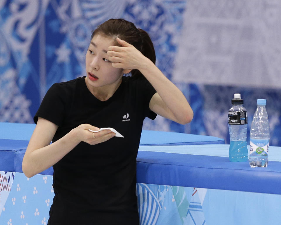 Yuna Kim of South Korea wipes her face during a practice session at the Iceberg Skating Palace during the 2014 Winter Olympics, Sunday, Feb. 16, 2014, in Sochi, Russia. (AP Photo/Darron Cummings)