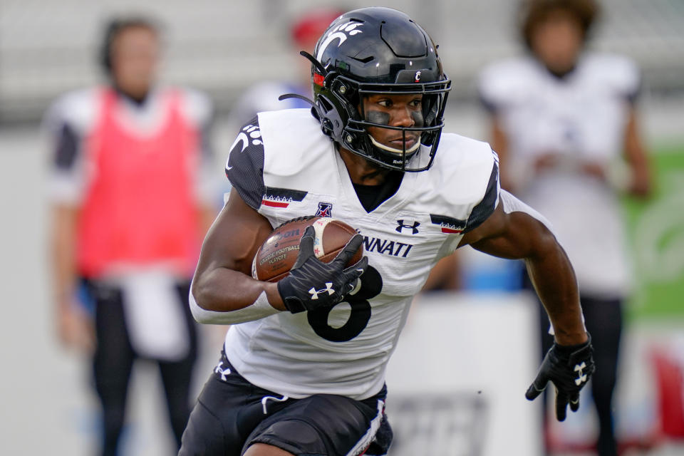 Cincinnati wide receiver Michael Young Jr. runs against Central Florida after a reception during the first half of an NCAA college football game, Saturday, Nov. 21, 2020, in Orlando, Fla. (AP Photo/John Raoux)