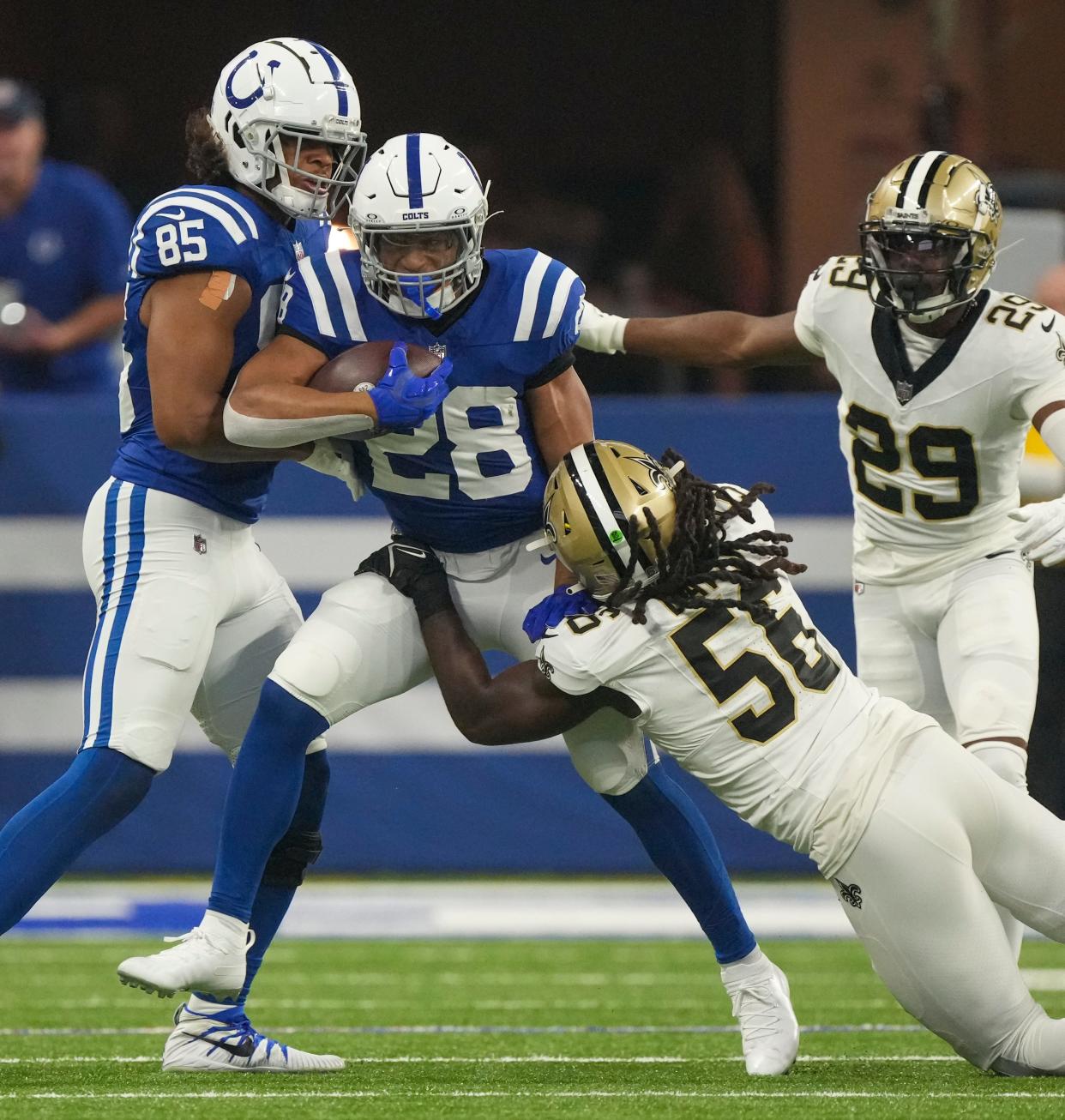 Indianapolis Colts running back Jonathan Taylor (28) is brought down by New Orleans Saints linebacker Demario Davis (56), Sunday., Oct 29, 2023, at Lucas Oil Stadium in Indianapolis.