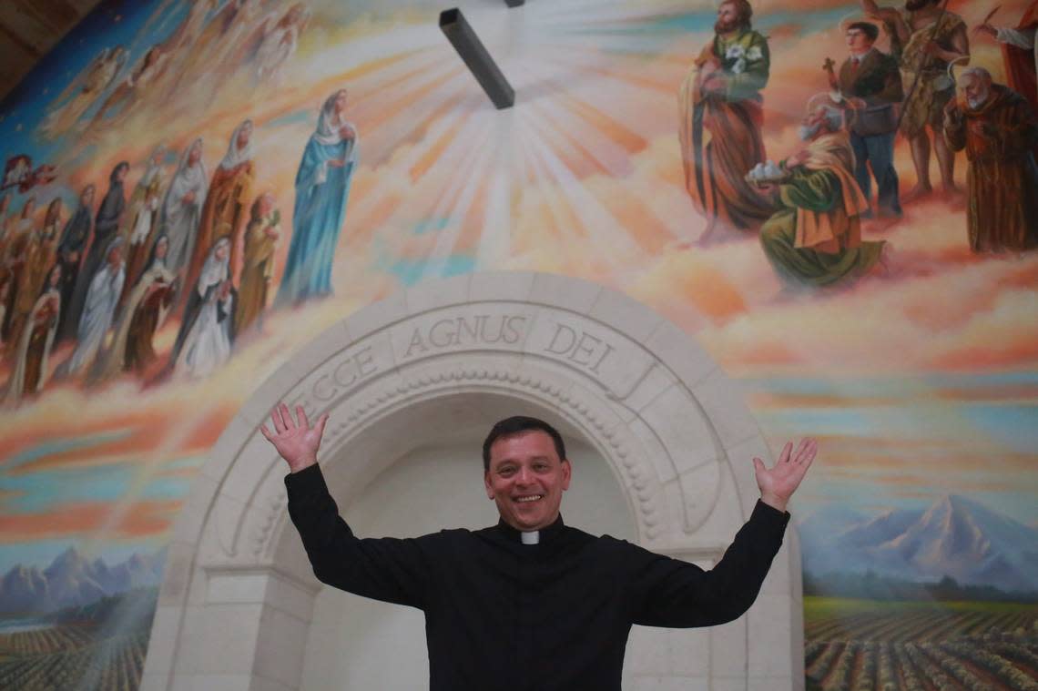  Pastor Fr. Alex Chávez in front of the St. Charles Borromeo Church’s retablo – the 48-by-53-foot mural on the wall behind the altar that was created by a studio out of San Francisco by a California artist.