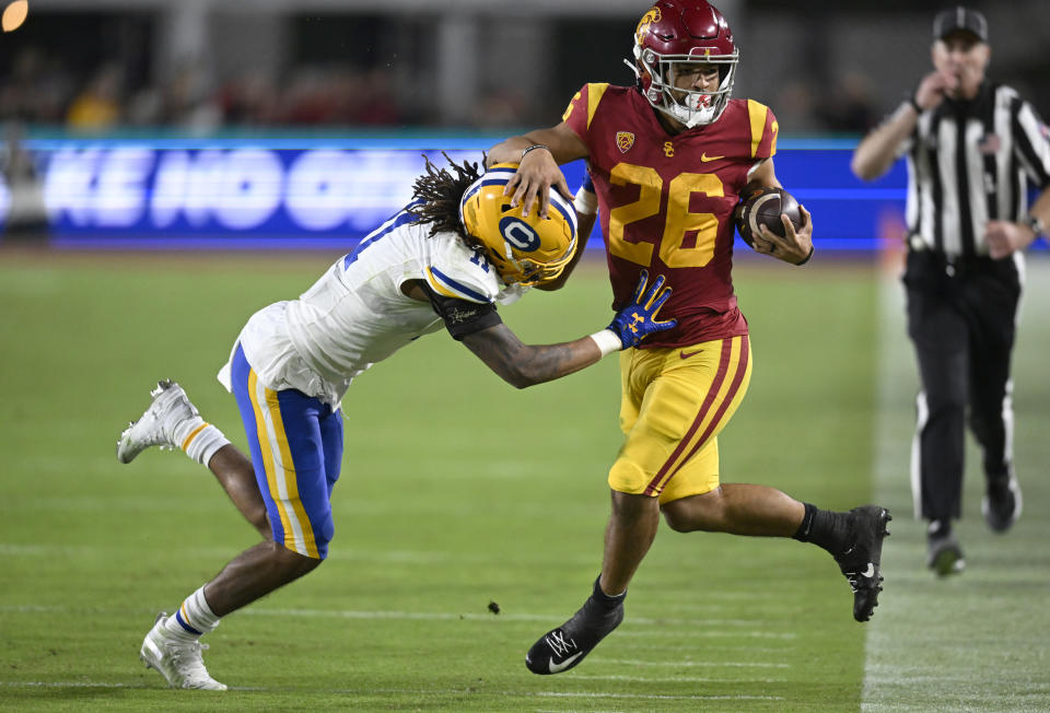 California cornerback Tyson McWilliams pushes Southern California running back Travis Dye (26) out of bounds during the second half of an NCAA college football game Saturday, Nov. 5, 2022, in Los Angeles. (AP Photo/John McCoy)