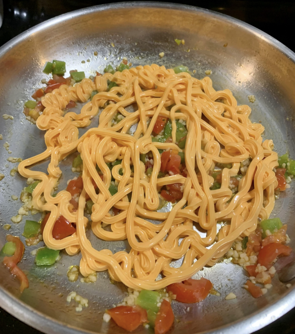 Spray cheese with diced vegetables in a pan