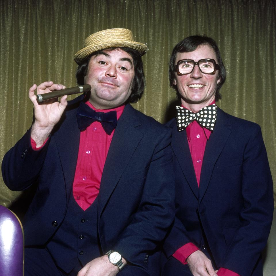 Portrait of British comedy team Little and Large, London, England, 1977. Starting as singers before switching to comedy, the duo consisted of Scottish comedian Eddie Large (born Edward McGinnis) (left) and English straight man Syd Little (born Cyril Mead). (Photo by George Wilkes/Hulton Archive/Getty Images)