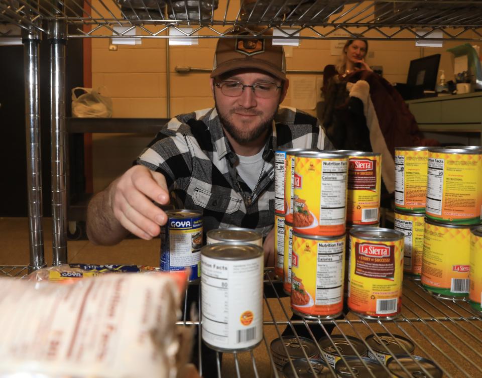 Dutchess Community College student Matthew Shayly stocks shelves with donated food while working at the DCC Pantry on December 14, 2022. The Pantry helps provide students in need with nutritional support. 