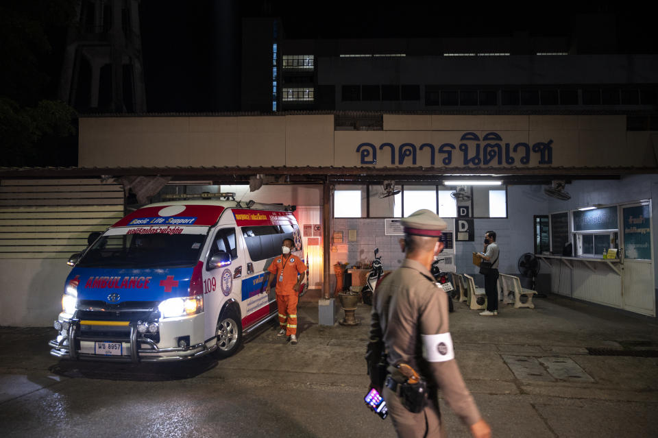 Police officers and health workers, pictured here preparing to load the body of Shane Warne from the morgue onto an ambulance.