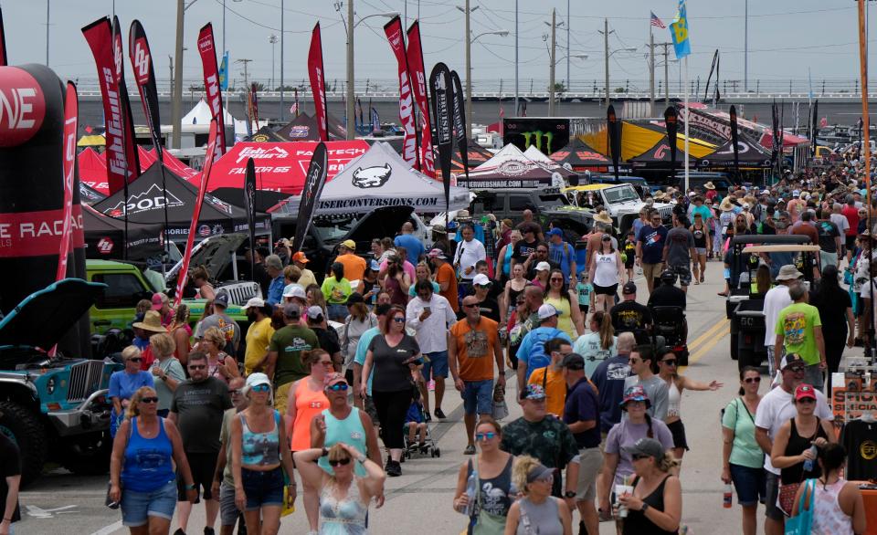 Crowds stroll the midway on Friday at the opening day of the Jeep Beach "Main Event" at Daytona International Speedway. The Speedway event continues on Saturday with activities that include a concert by pop singer-songwriter Colbie Caillat.