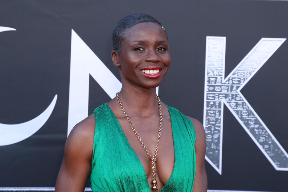 Ann Akinjirin in a sleeveless dress smiling at the camera