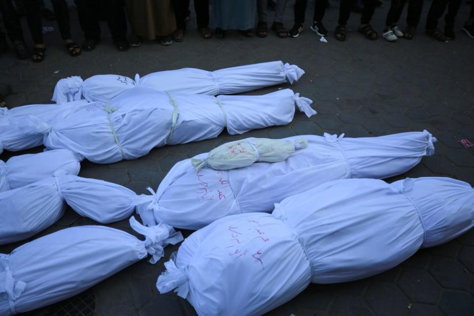 Relatives mourn as bodies are carried for burial outside Al Aqsa Martyrs Hospital in Deir al-Balah in the central Gaza Strip, on Oct. 31.<span class="copyright">Majdi Fathi/NurPhoto/Getty Images</span>