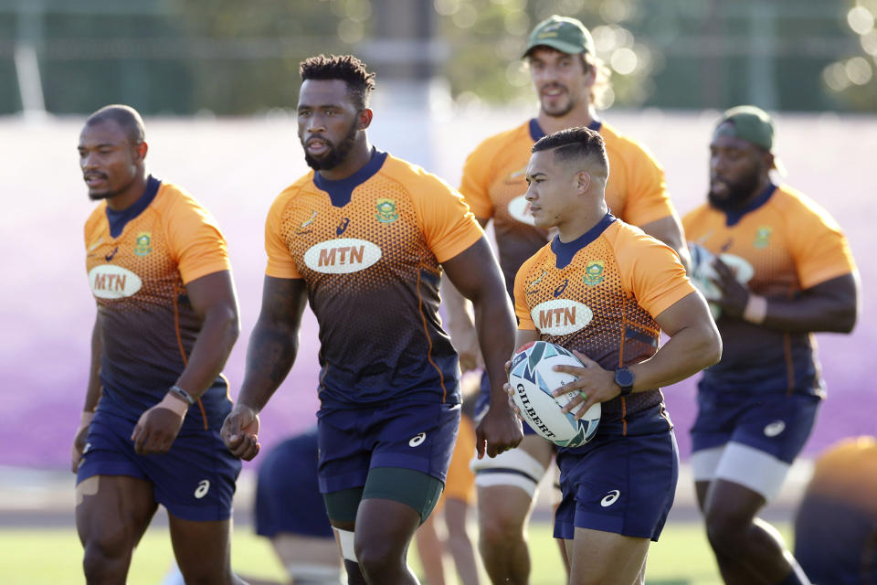 South Africa's Cheslin Kolbe, right, and Siya Kolisi, second right, take part in the team's training in Urayasu, near Tokyo Tuesday, Sept. 17, 2019, ahead of Rugby World Cup match against New Zealand. (Takumi Sato/Kyodo News via AP)