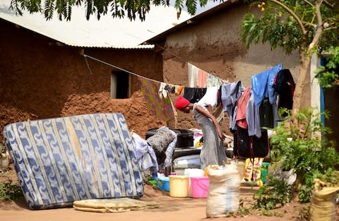 One family organises their belongings outside of their home during an IRS campaign - Credit: Maggie Andresen&nbsp;