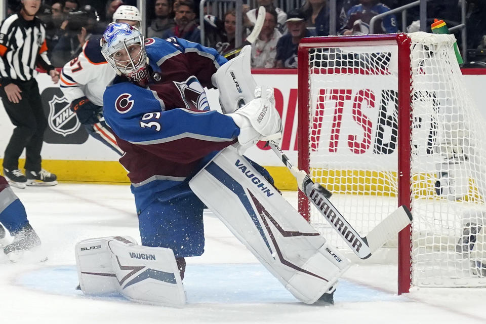 Colorado Avalanche goaltender Pavel Francouz (39) clears the puck during the second period in Game 2 of the team's NHL hockey Stanley Cup playoffs Western Conference finals against the Edmonton Oilers on Thursday, June 2, 2022, in Denver. (AP Photo/Jack Dempsey)