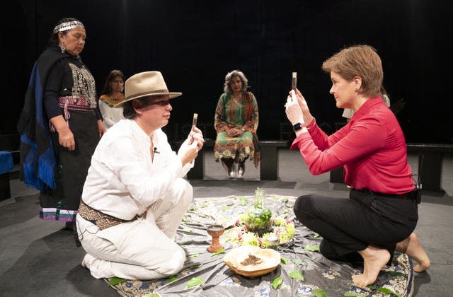 First Minister Nicola Sturgeon welcomes Mapuche leader and Minga Indigena Lead Coordinator Claflin Lafkenche (left) alongside indigenous delegates at a ceremonial gathering at the Tramway in Glasgow in a symbolic gesture to mark a unified demand for climate justice