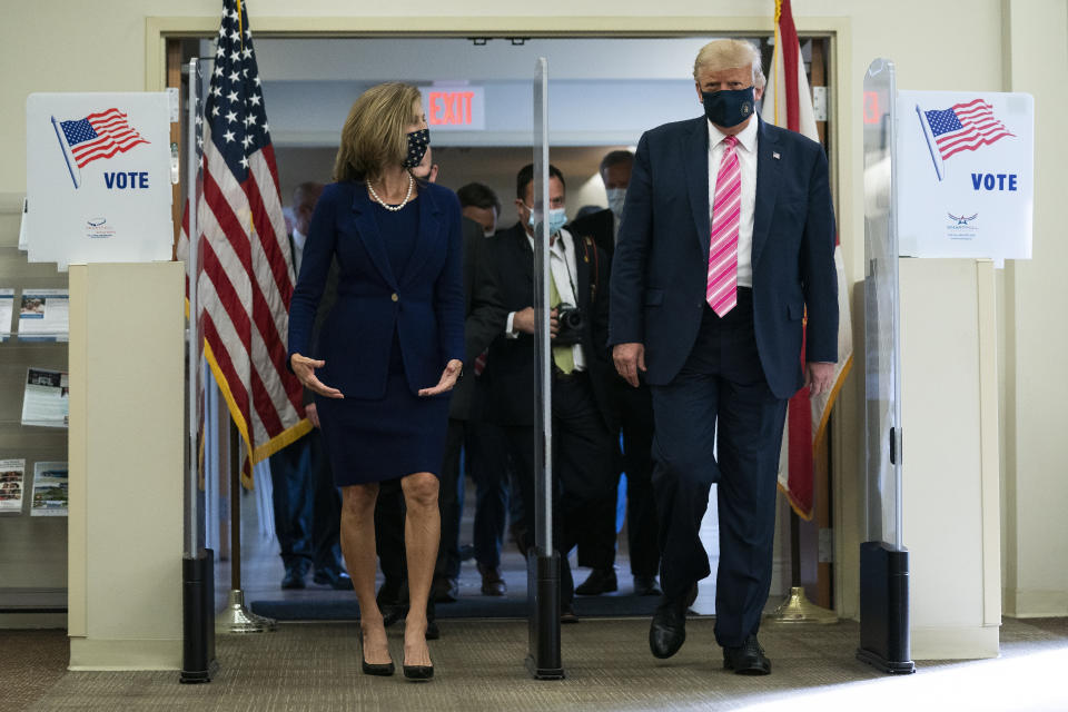 President Donald Trump walks with Wendy Sartory Link, Supervisor of Elections Palm Beach County, after casting his ballot for the presidential election, Saturday, Oct. 24, 2020, in West Palm Beach, Fla. (AP Photo/Evan Vucci)