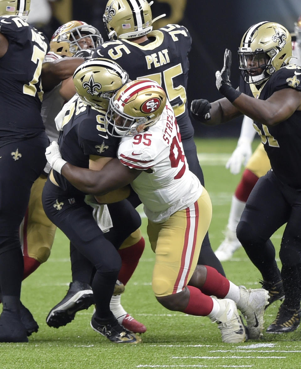 New Orleans Saints quarterback Drew Brees (9) is sacked by San Francisco 49ers' Kentavius Street (95) during the second quarter of an NFL football game in New Orleans, Sunday, Nov. 15, 2020. Brees has been diagnosed with multiple rib fractures and a collapsed right lung, a person with knowledge of the situation said Monday. The person spoke on condition of anonymity because the Saints have not announced specifics about Brees' injury, which the 41-year-old quarterback said occurred on a heavy hit by Street in the second quarter of New Orleans victory over the Niners on Sunday. (Max Becherer/The Advocate via AP)